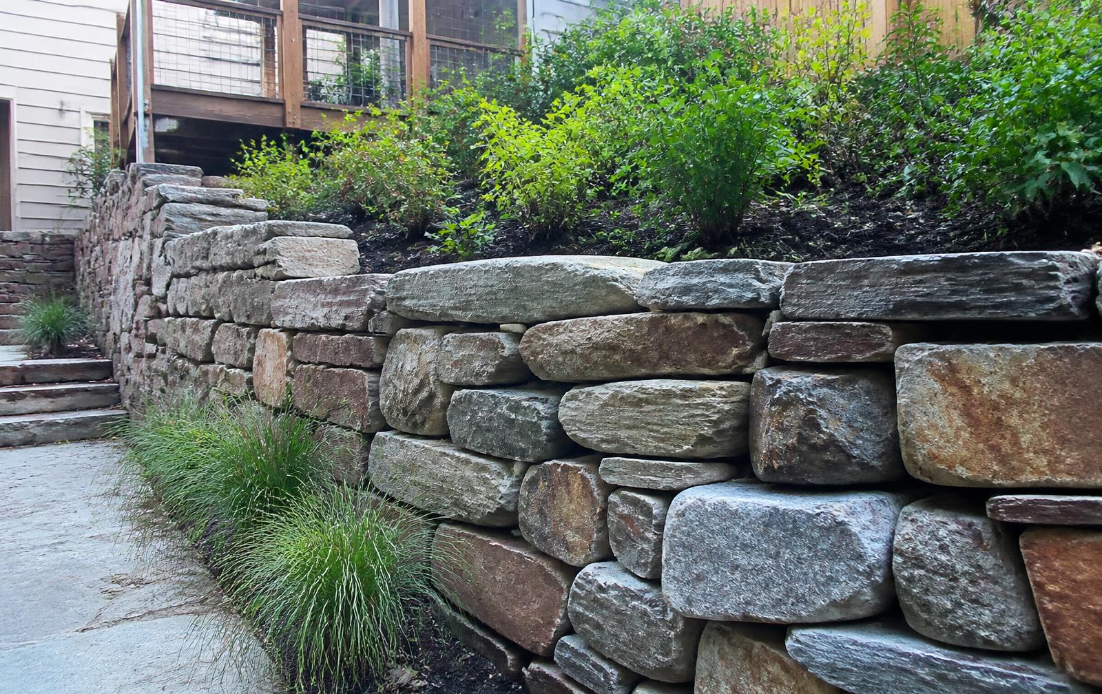 Stacked natural stone retaining wall