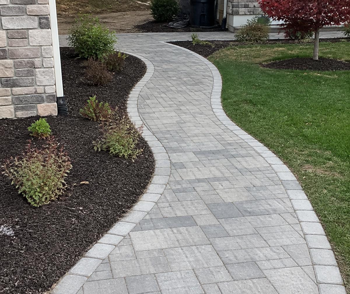 Stone walkway through a flowering garden